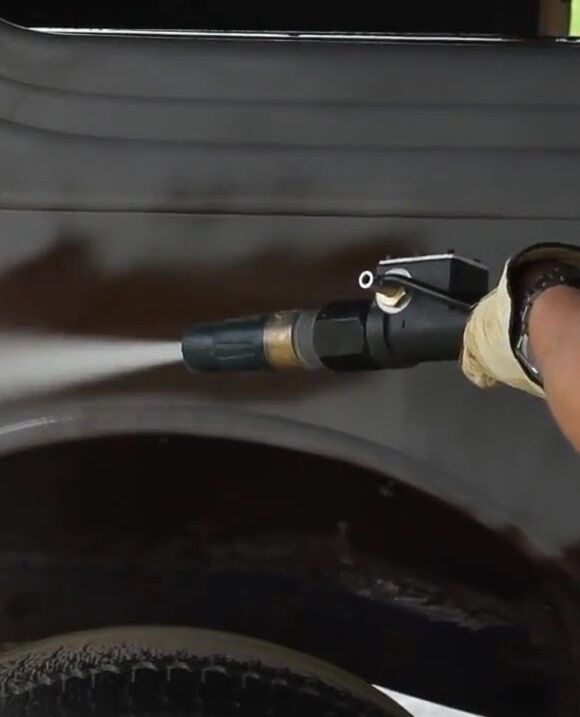 A lance cutting coating away from a curved vehicle panel