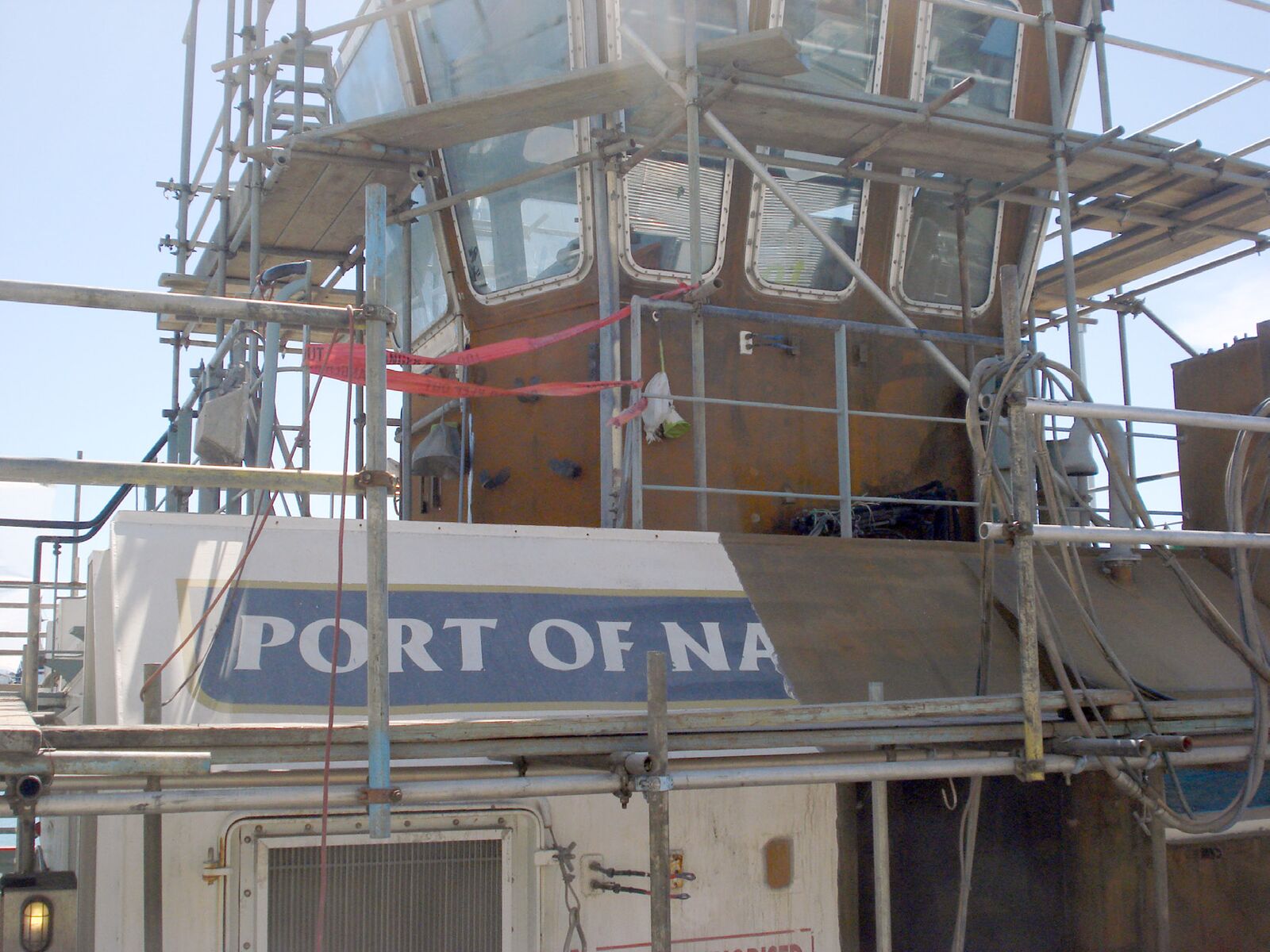 The wheelhouse of a Port of Napier tug inside scaffolding during coating removal